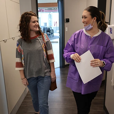 Santana and Patient Walking to a Room at Singing River Dentistry in Muscle Shoals, AL.