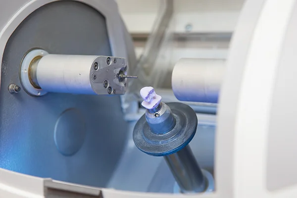 Close up of a CEREC machine milling a new dental crown