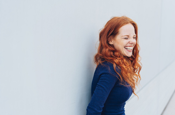 beautiful redheaded woman side portrait laughing